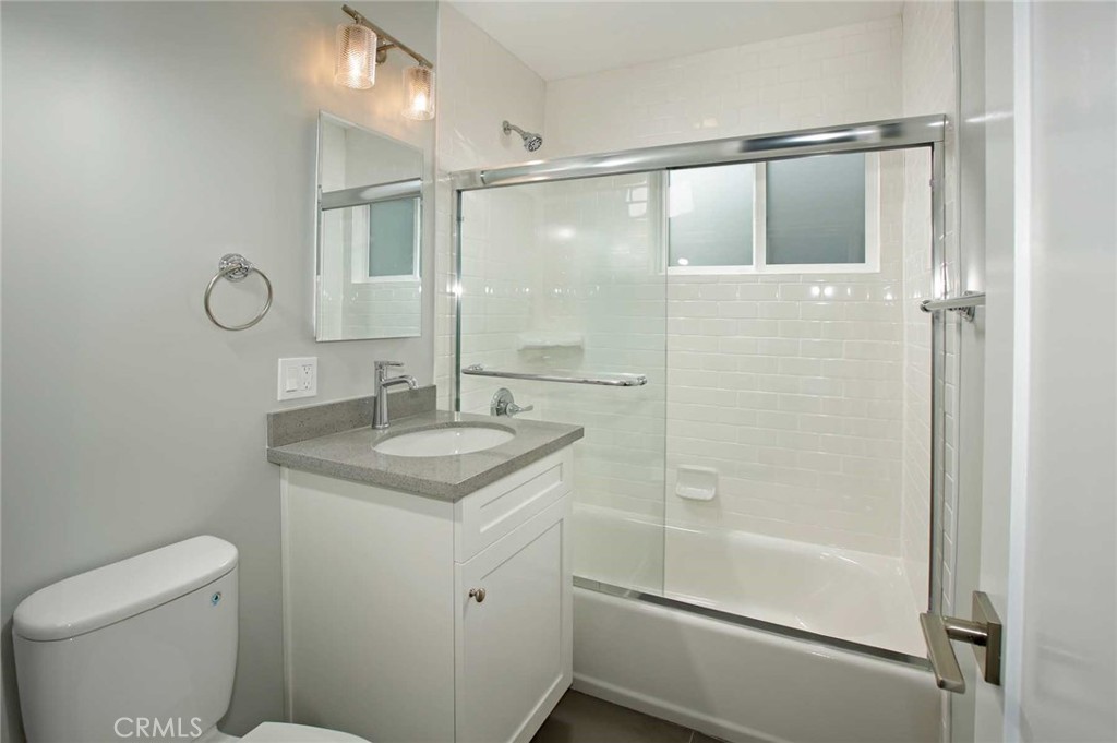 5459 Carlin Street, Unit 1 Los Angeles, CA 90016 - Photo 22 of 22 a bathroom with a granite countertop sink toilet and shower