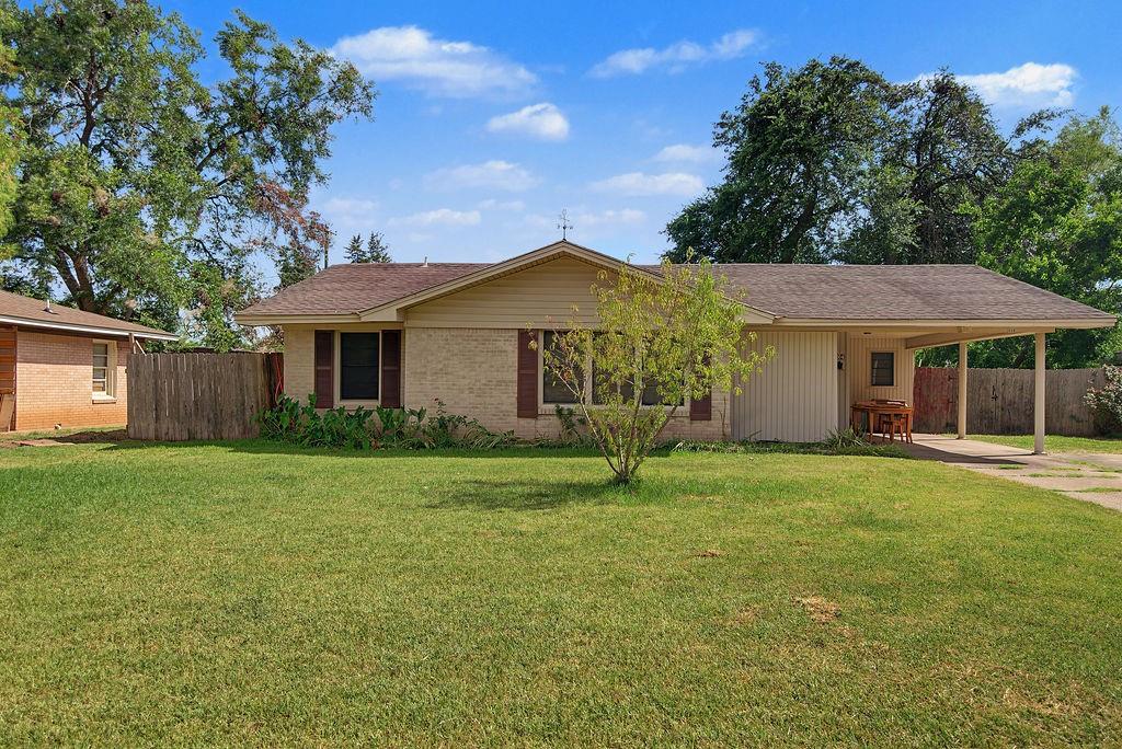 2604 Rosedale Place Bossier City, LA 71111 - Photo 2 of 26 Brick and siding exterior, front yard with mature trees, attached carport, and a dark shingle roof