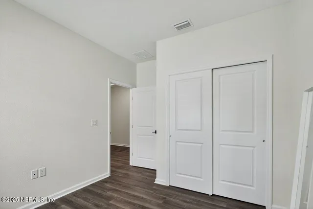 a view of a workspace with furniture and a bookshelf