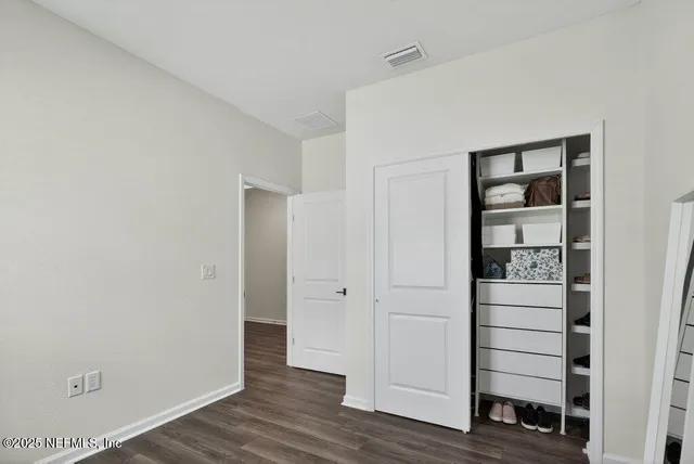a view of washer and dryer with wooden cabinet