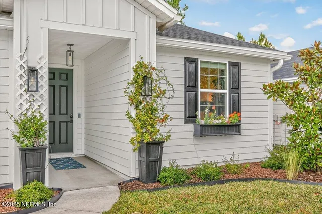 a potted plant sitting in front of a house