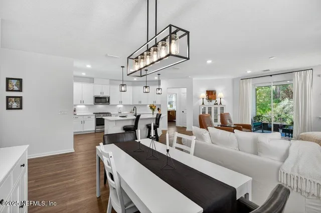 a kitchen with stainless steel appliances granite countertop a sink a stove top oven a counter space and cabinets