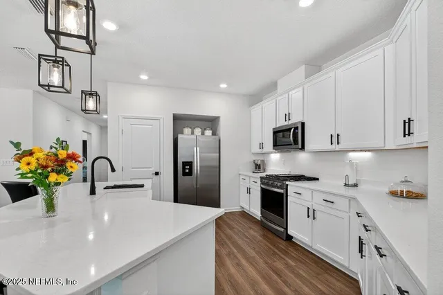 a living room with furniture a flat screen tv and large windows