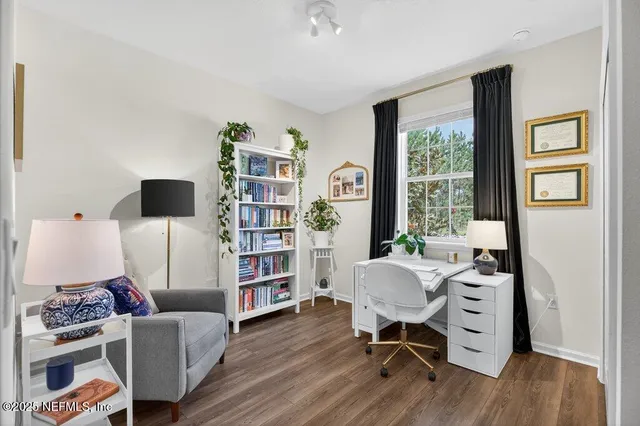 a living room filled with furniture and a potted plant