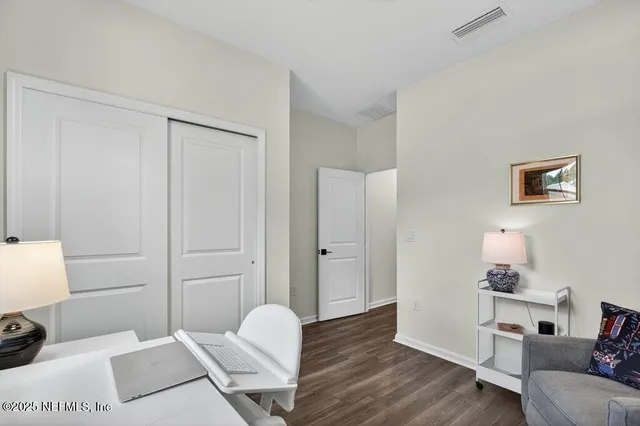 a bathroom with a sink vanity mirror and toilet