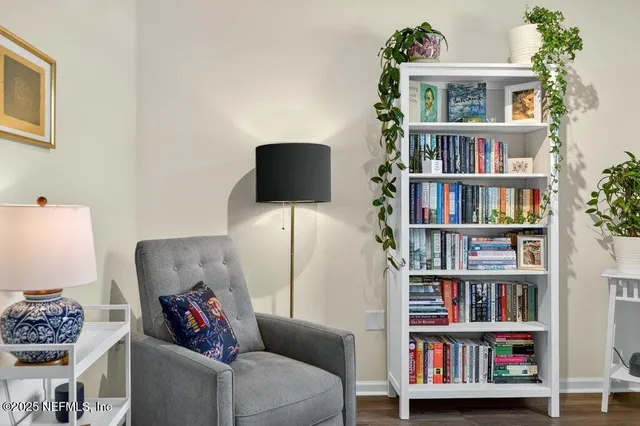 a living room with hard wood floors and a window