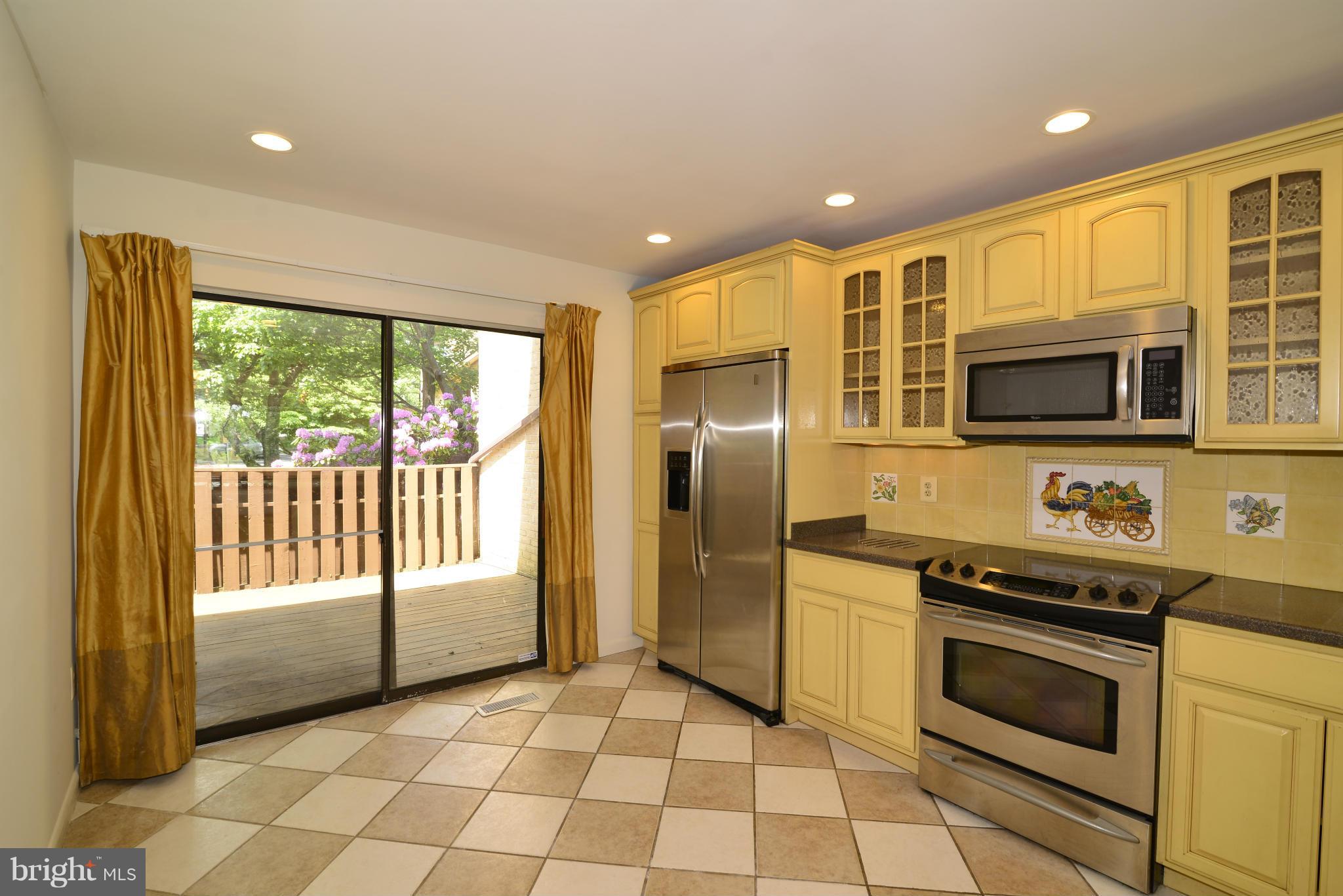 11212 Lagoon Lane Reston, VA 20191 - Photo 3 of 24 The kitchen leads to the fully-fenced front deck.