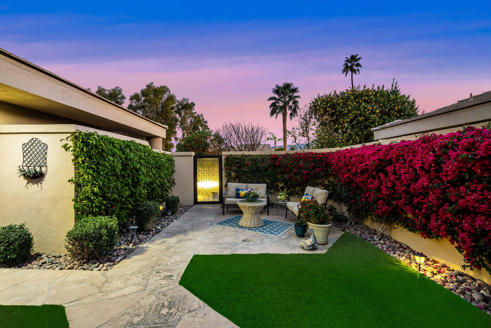 80449 Pebble Beach La Quinta, CA 92253 - Photo 23 of 60 a view of a backyard with potted plants and a large tree