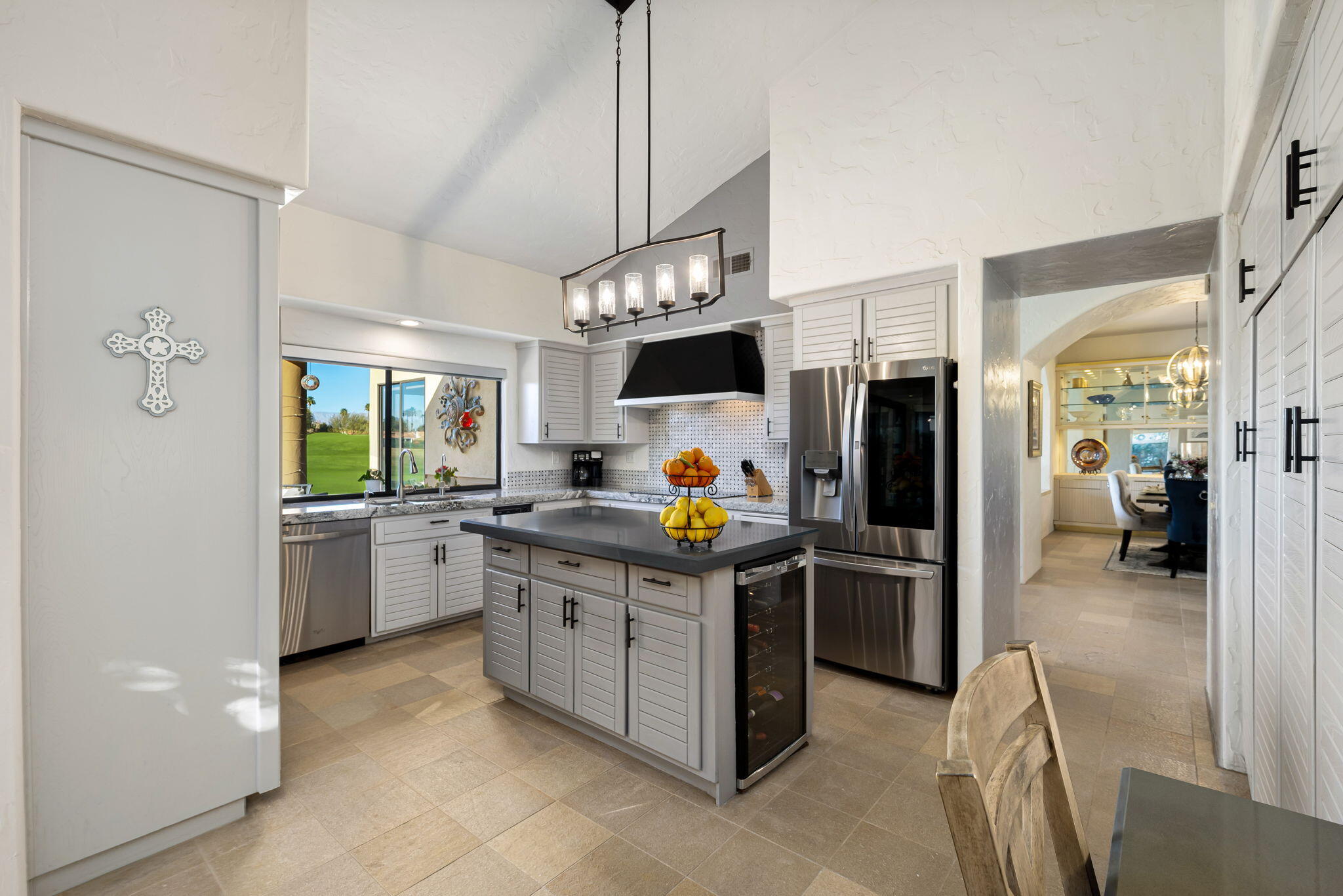 80449 Pebble Beach La Quinta, CA 92253 - Photo 43 of 60 a kitchen with stainless steel appliances granite countertop a stove a refrigerator a sink a oven with a dining table and chairs