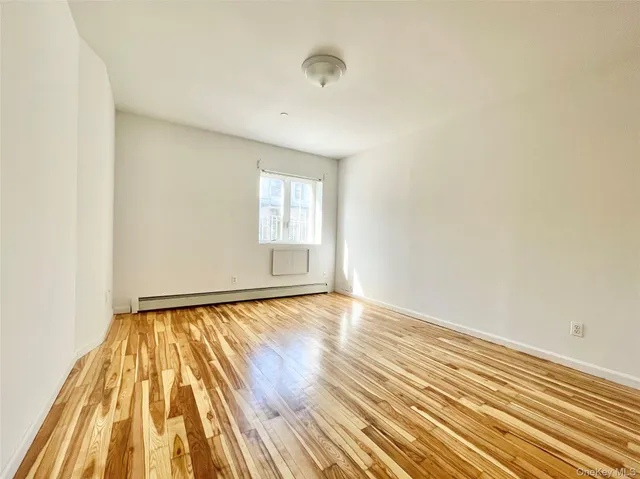 a view of an empty room and wooden floor