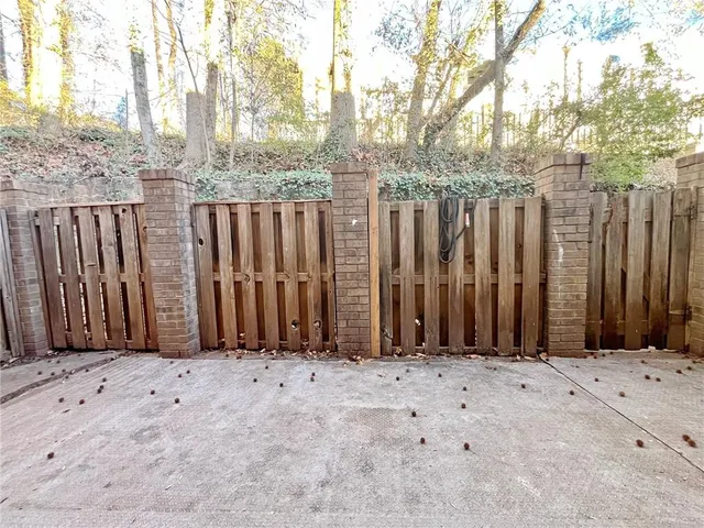 a view of a pathway along with brick wall