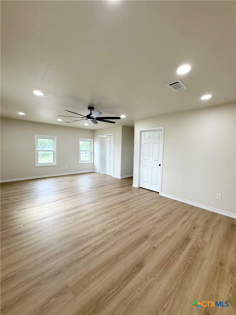 421 South 32nd Street Temple, TX 76501 - Photo 11 of 27 an empty room with wooden floor and windows