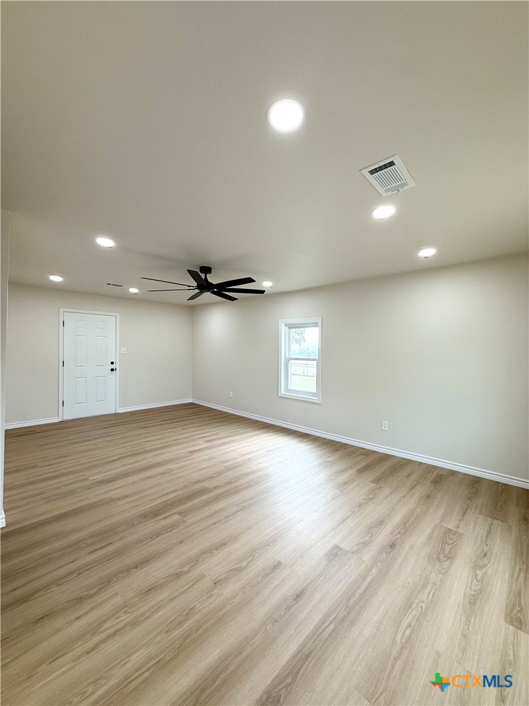 421 South 32nd Street Temple, TX 76501 - Photo 12 of 27 an empty room with wooden floor and windows