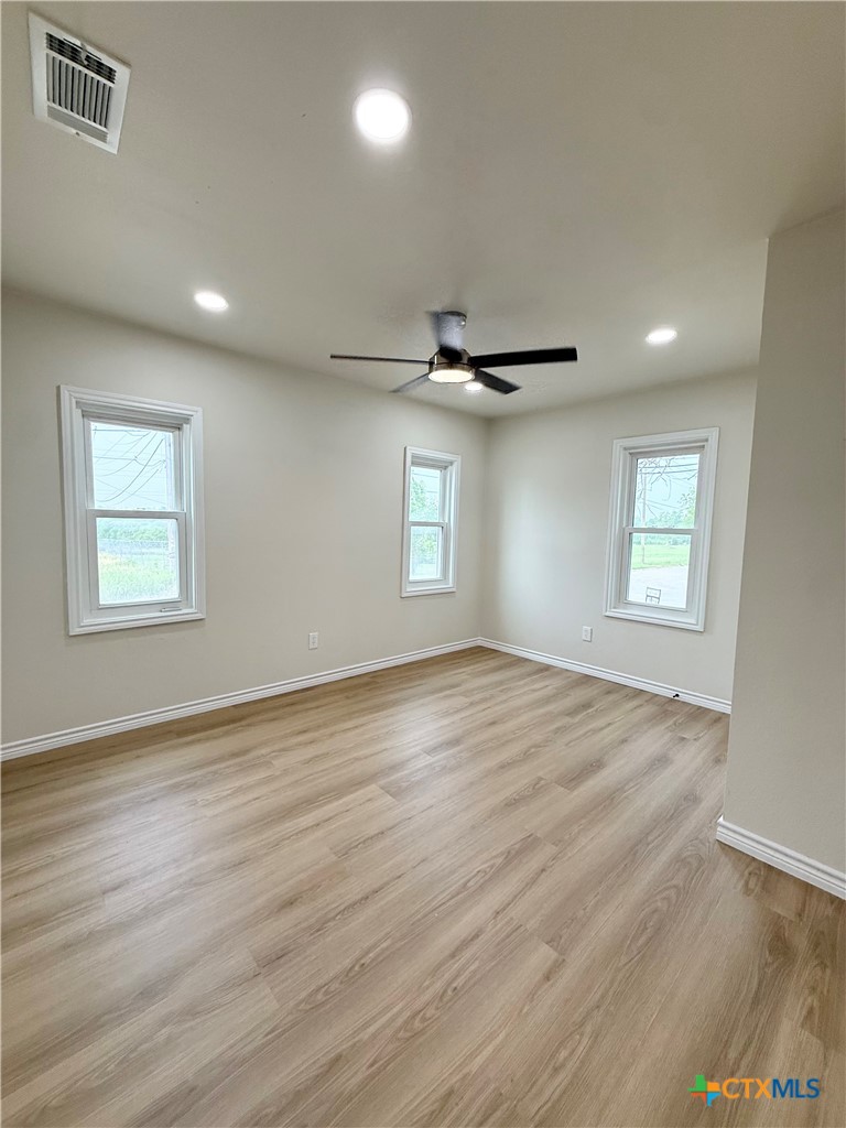 421 South 32nd Street Temple, TX 76501 - Photo 17 of 27 a view of empty room with wooden floor and fan
