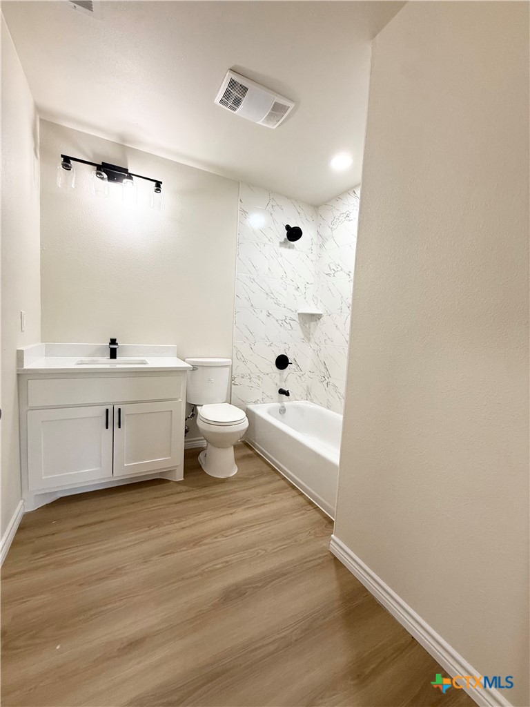 421 South 32nd Street Temple, TX 76501 - Photo 19 of 27 a bathroom with a sink a toilet and shower