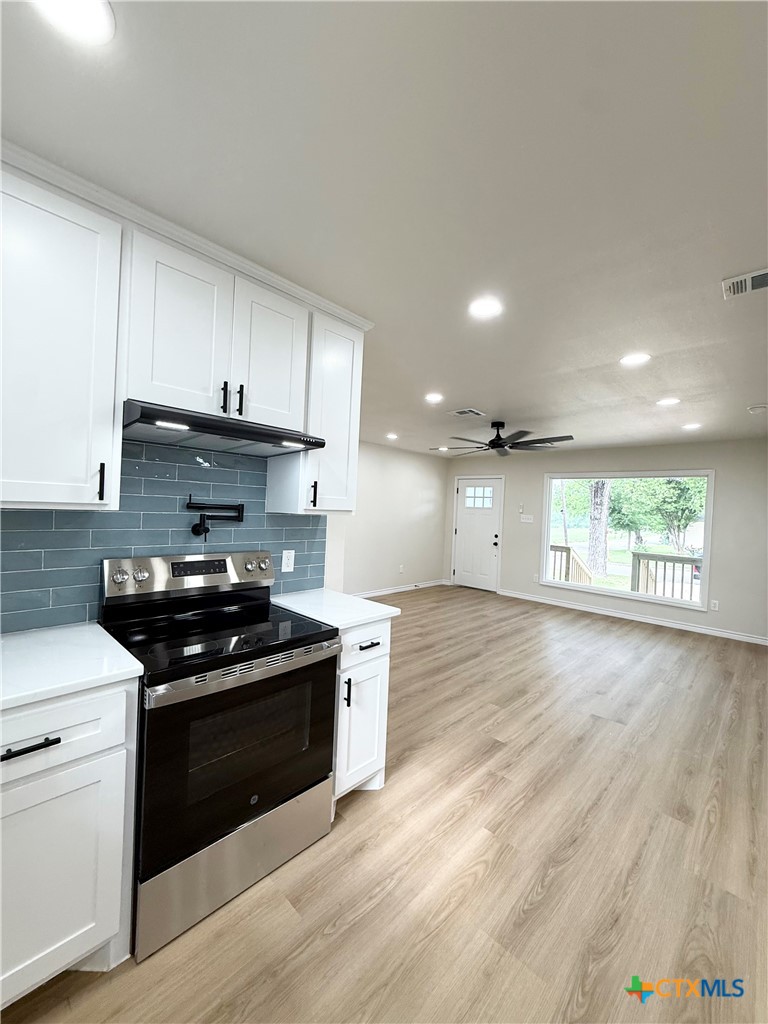 421 South 32nd Street Temple, TX 76501 - Photo 4 of 27 a kitchen with stainless steel appliances granite countertop a stove a sink and a refrigerator