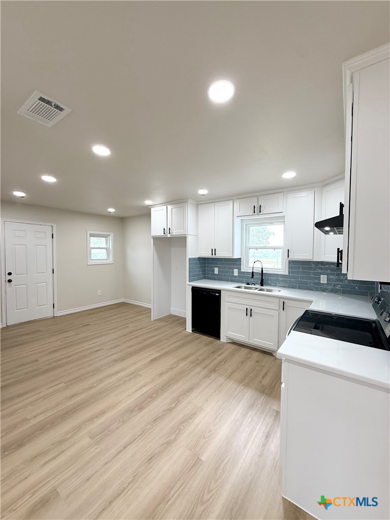 421 South 32nd Street Temple, TX 76501 - Photo 5 of 27 a large white kitchen with kitchen island a sink stainless steel appliances and cabinets