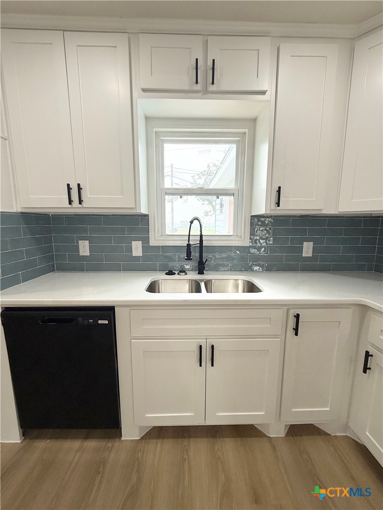 421 South 32nd Street Temple, TX 76501 - Photo 6 of 27 a kitchen with a sink a window and cabinets