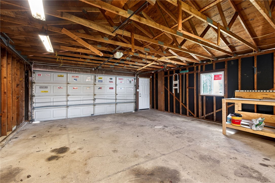 5975 Rosalie Road Dayton, OH 45424 - Photo 32 of 48 An expansive garage with exposed wood beams offers ample space for vehicles and projects.