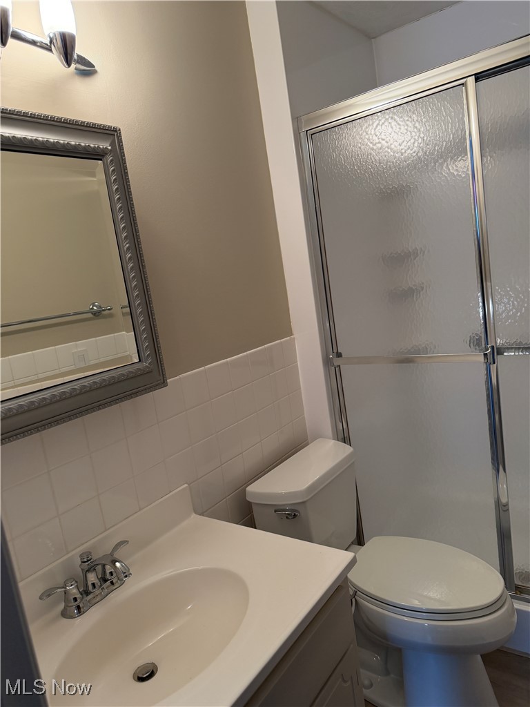 3066 Kent Road, Unit 407 Stow, OH 44224 - Photo 6 of 16 Bathroom with vanity, a shower stall, and tile walls