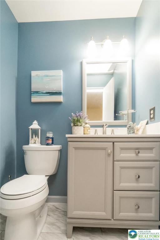 4759 Egypt Road Coplay, PA 18037 - Photo 17 of 30 a bathroom with a toilet a sink and mirror
