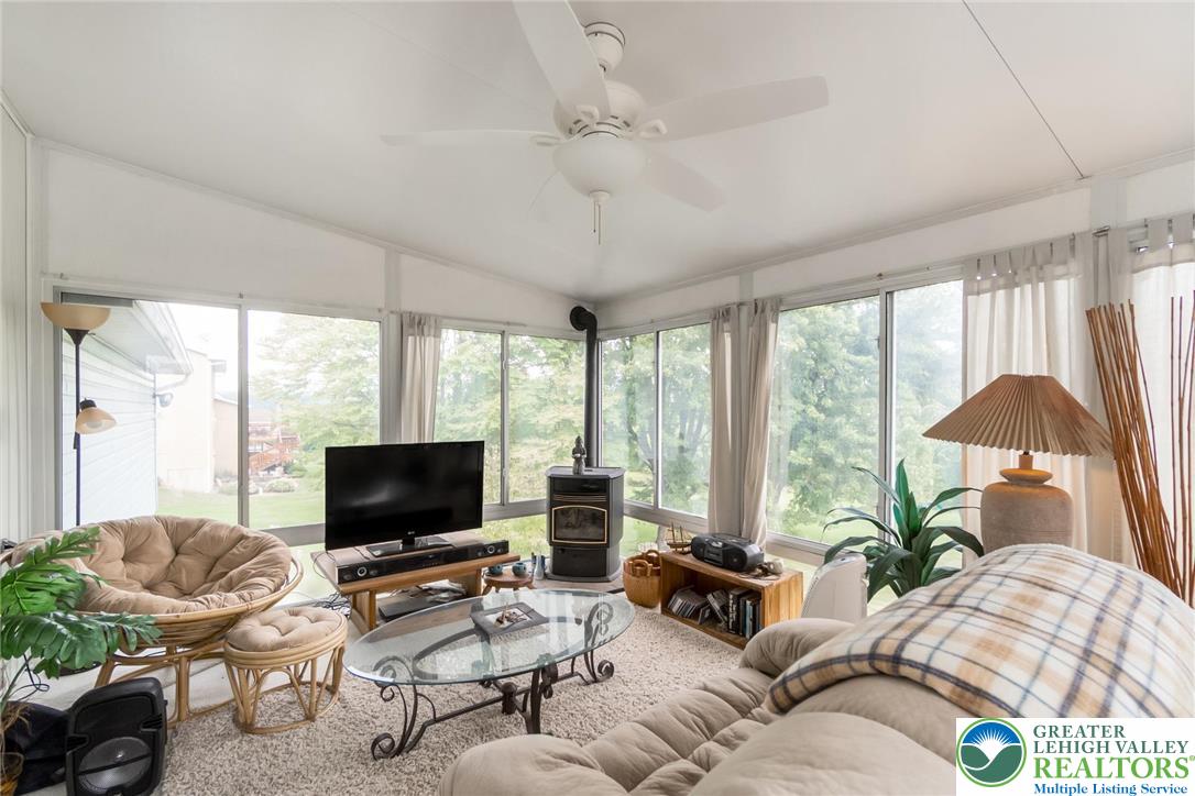 4759 Egypt Road Coplay, PA 18037 - Photo 18 of 30 a living room with furniture a flat screen tv and a large window