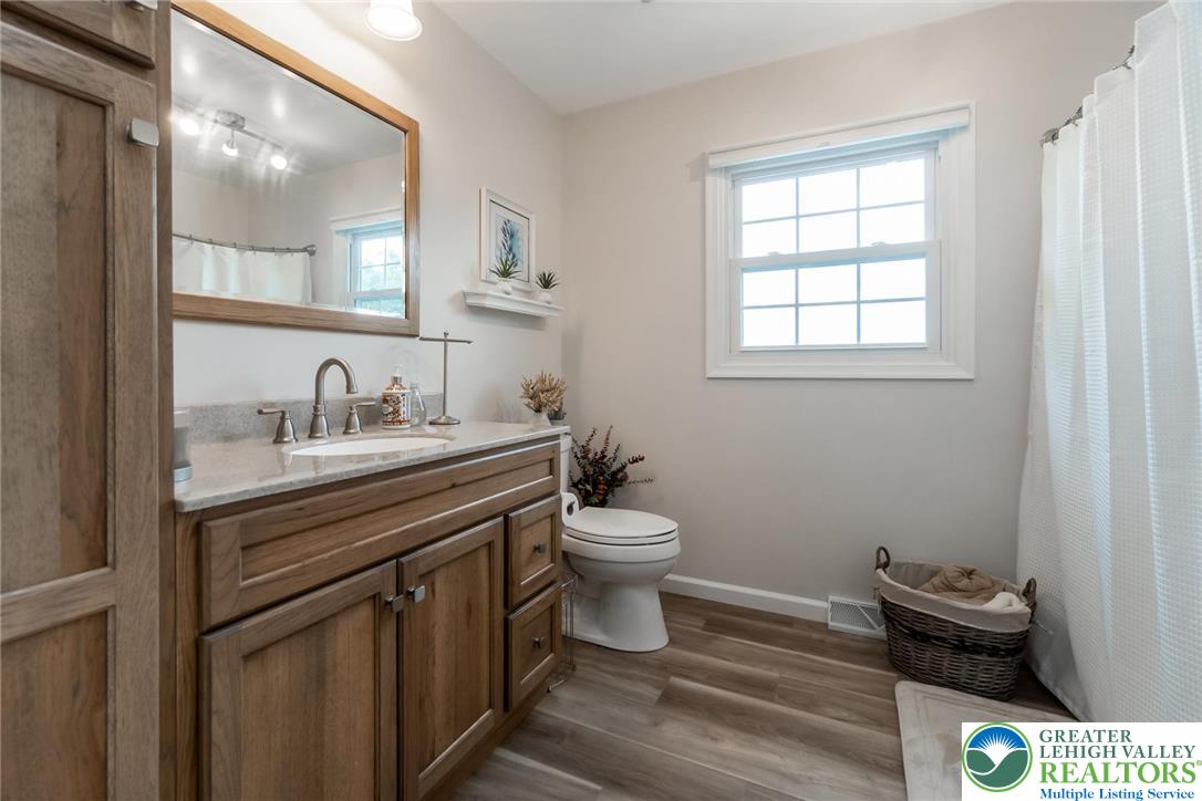 4759 Egypt Road Coplay, PA 18037 - Photo 24 of 30 a bathroom with a toilet a sink and mirror