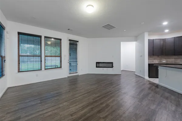a view of kitchen with sink and refrigerator