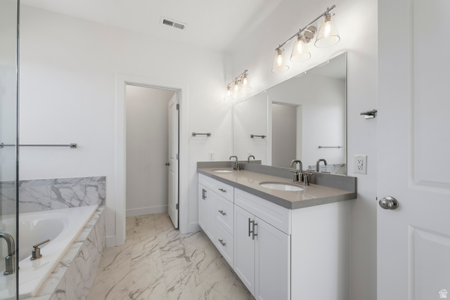 58 South Crimson Way, Unit 306 Mapleton, UT 84664 - Photo 22 of 24 Spacious bathroom featuring a dual vanity with a light-toned countertop, a large mirror, and overhead lighting fixtures
