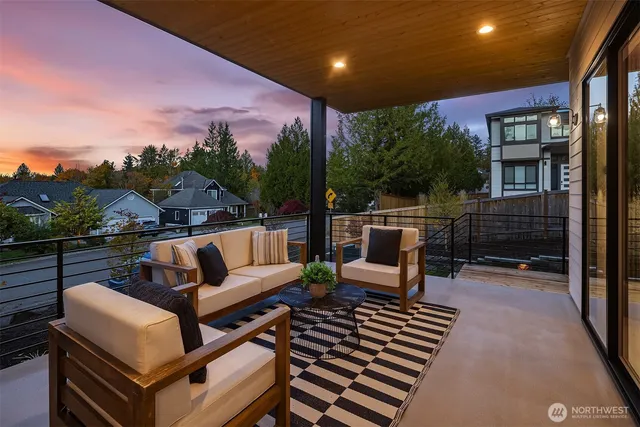 a view of a roof deck with couches and wooden floor