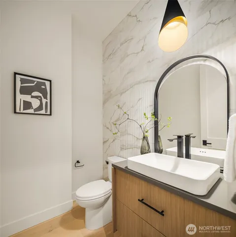 a bathroom with a toilet sink and mirror