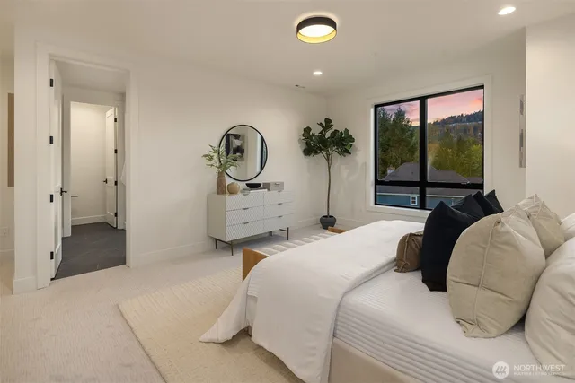 a bedroom with a bed and a large window