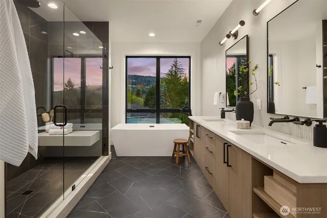 a bathroom with a large tub sink and double vanity