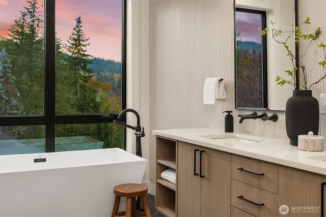 a bathroom with a tub sink and mirror
