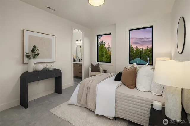 a bedroom with double bed and a painting on the wall