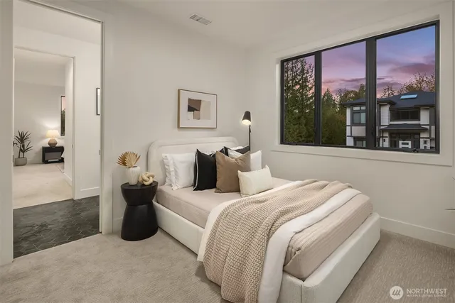 a bedroom with bed and a large window