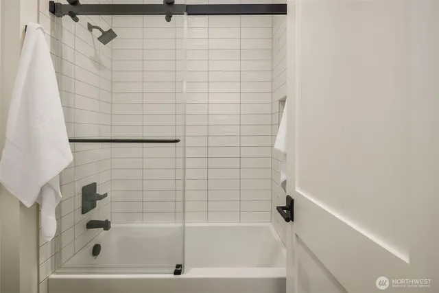 a bathroom with a shower and a bathtub