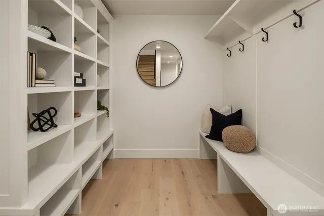 a hallway with a large mirror and a wooden floor