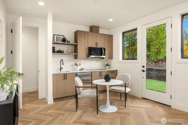 a dining room with furniture and a floor to ceiling window