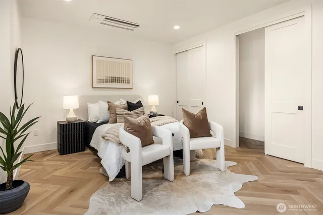 a bed room with furniture and a potted plant