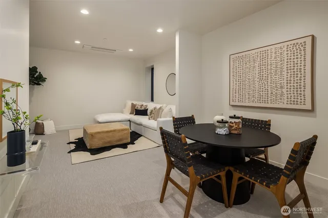 a view of a dining room with furniture and a potted plant
