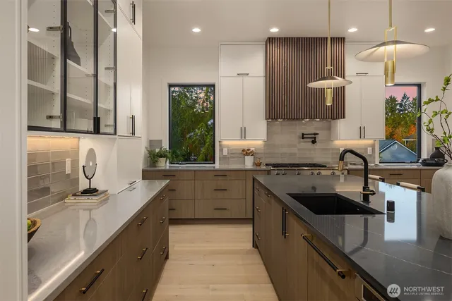 a kitchen with stainless steel appliances a sink stove and cabinets
