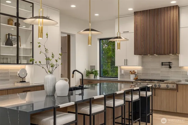 a kitchen with sink table and chairs