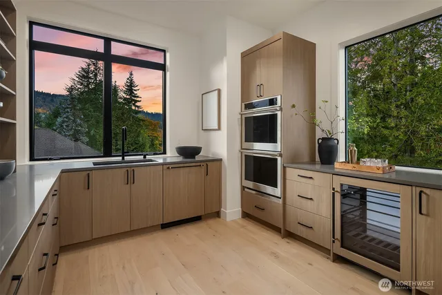 a kitchen with white cabinets and white appliances