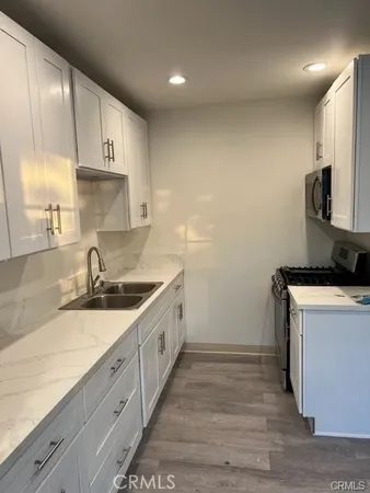 a kitchen with sink cabinets and appliances