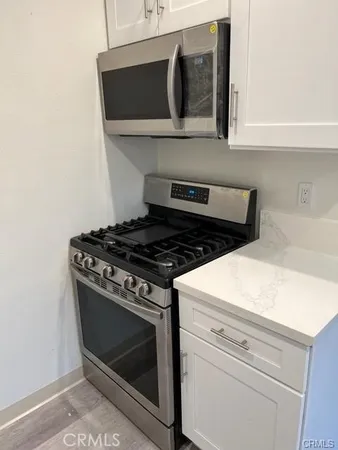 a stove top oven sitting inside of a kitchen