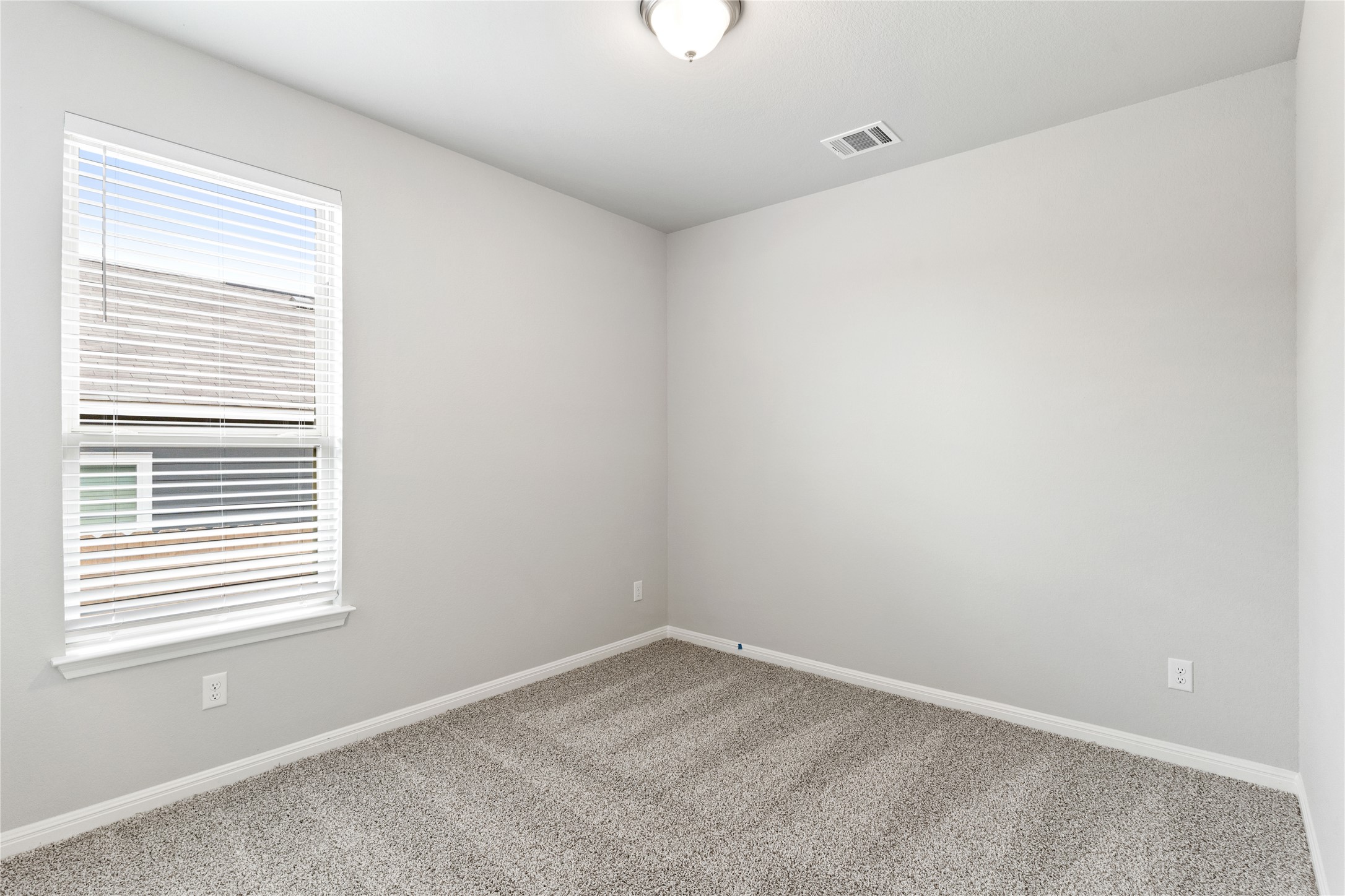 313 Mclintock Road Jarrell, TX 76537 - Photo 6 of 17 A well-lit bedroom features plush carpeting and a bright window.