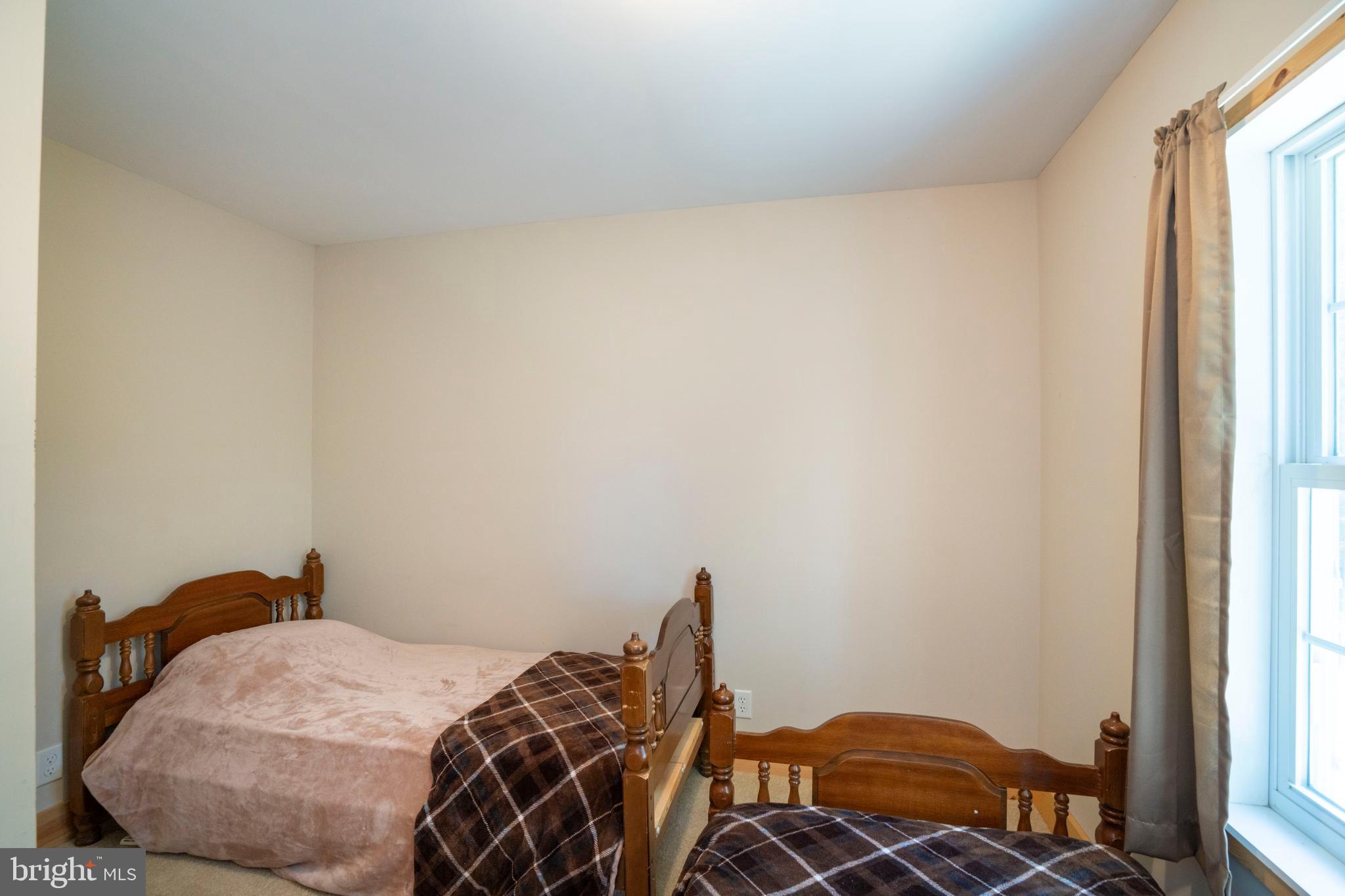 385 Elk Creek Road Aaronsburg, PA 16820 - Photo 53 of 71 a bedroom with a bed and wooden floor