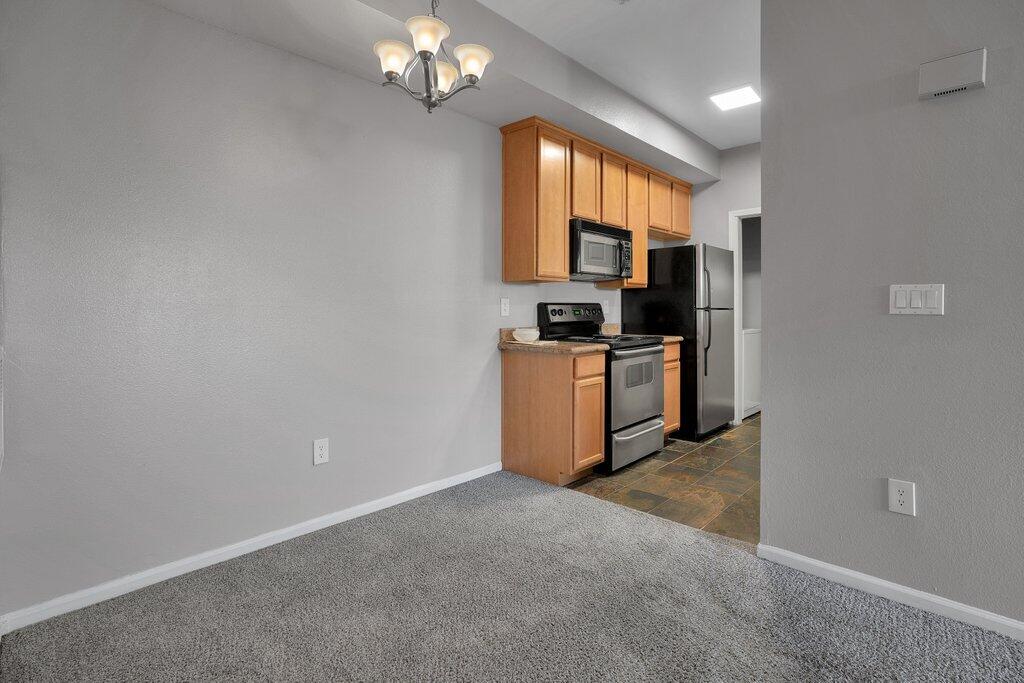 375 Central Avenue, Unit 10 Riverside, CA 92507 - Photo 4 of 33 a view of a kitchen with a sink and dishwasher a refrigerator with wooden floor