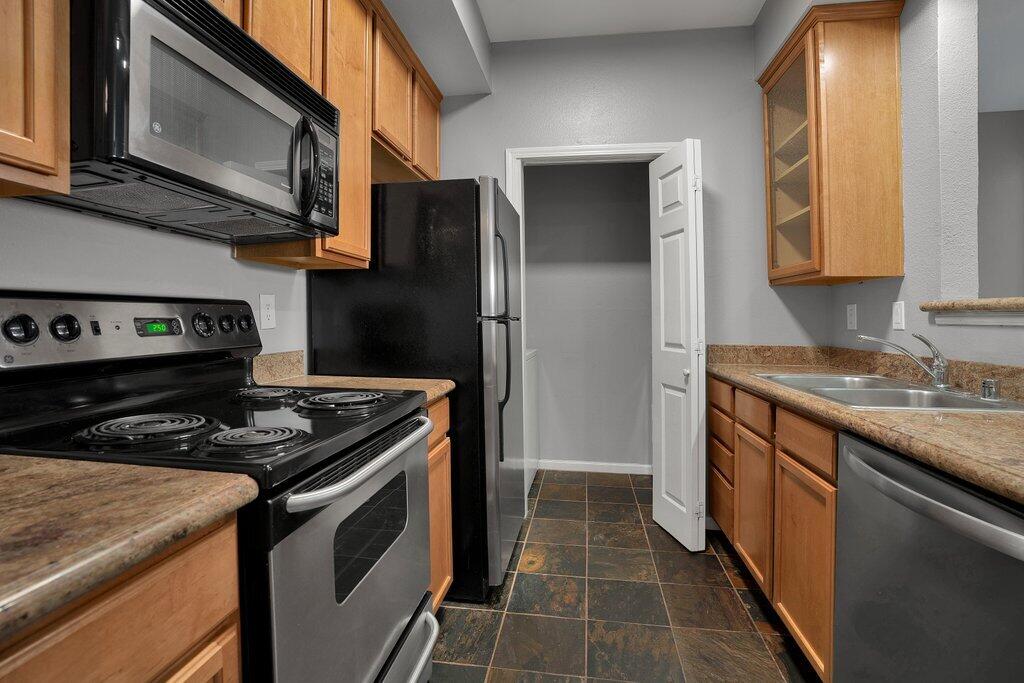 375 Central Avenue, Unit 10 Riverside, CA 92507 - Photo 8 of 33 a kitchen with stainless steel appliances granite countertop a stove and a refrigerator